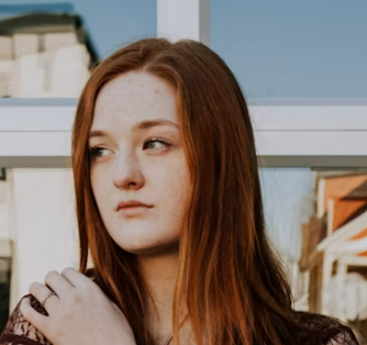 Woman with red hair in sunlight.
